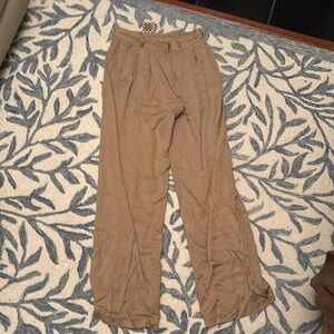 Tan wide leg trousers dressed in Lala trendy